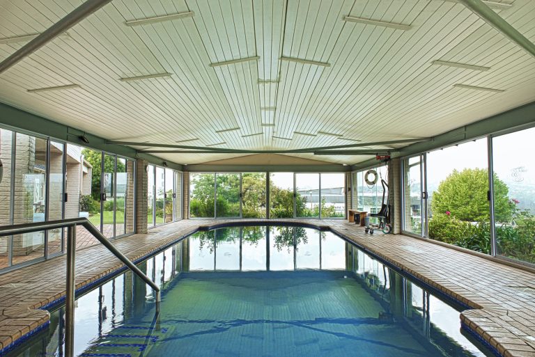 Fish and Field Biokineticists Off Nicol practice view of aquatic therapy pool area with blue water and glass windows with view